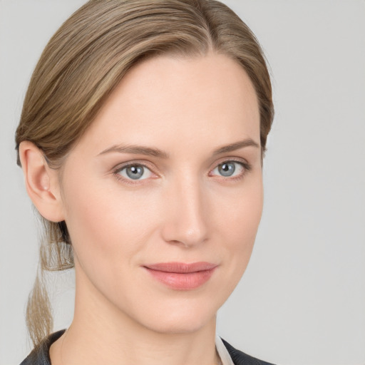 Joyful white young-adult female with medium  brown hair and blue eyes