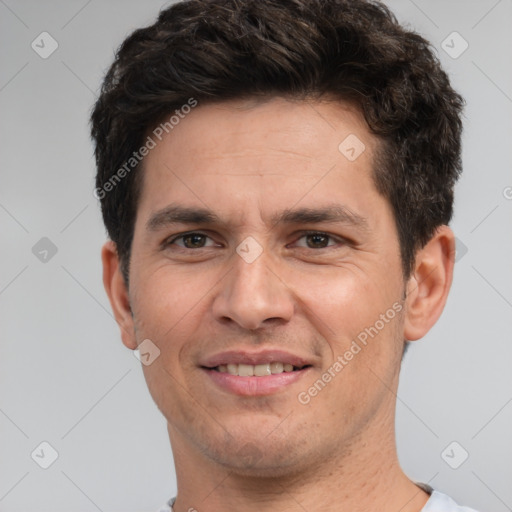 Joyful white adult male with short  brown hair and brown eyes