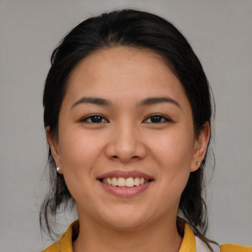 Joyful asian young-adult female with medium  brown hair and brown eyes