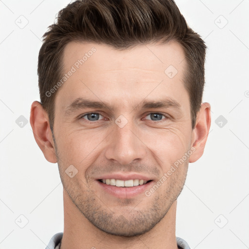 Joyful white young-adult male with short  brown hair and grey eyes