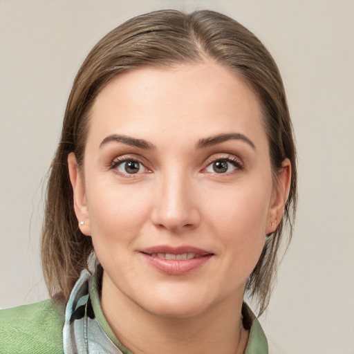 Joyful white young-adult female with medium  brown hair and grey eyes