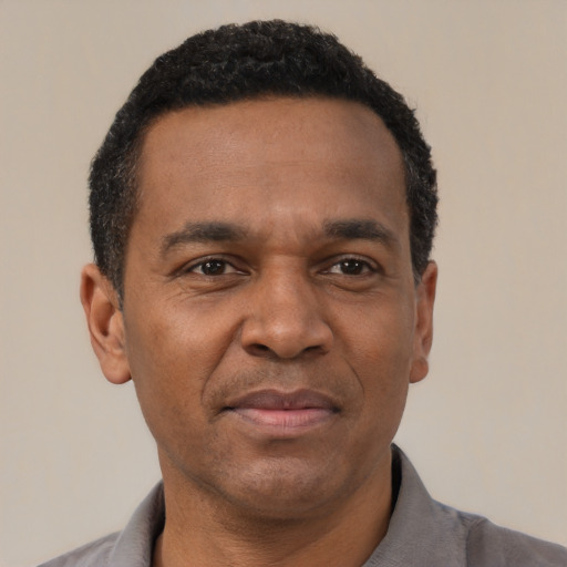 Joyful latino adult male with short  brown hair and brown eyes