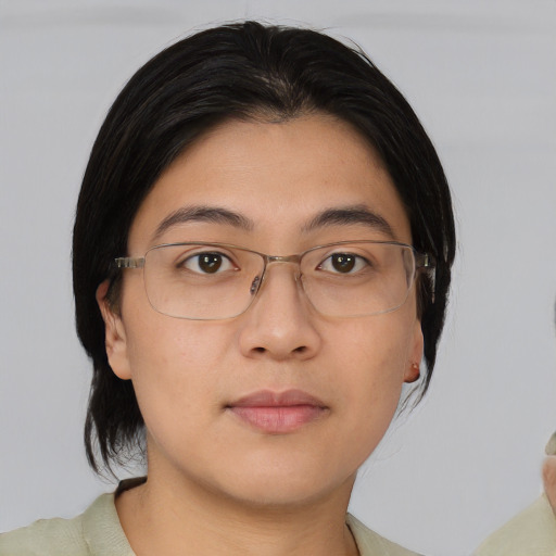 Joyful asian young-adult female with medium  black hair and brown eyes