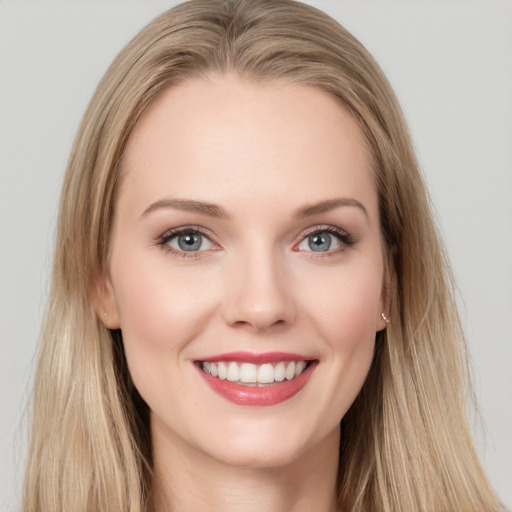 Joyful white young-adult female with long  brown hair and grey eyes