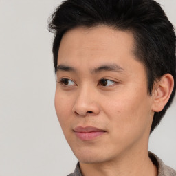 Joyful asian young-adult male with medium  brown hair and brown eyes