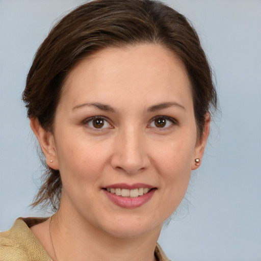 Joyful white young-adult female with medium  brown hair and brown eyes