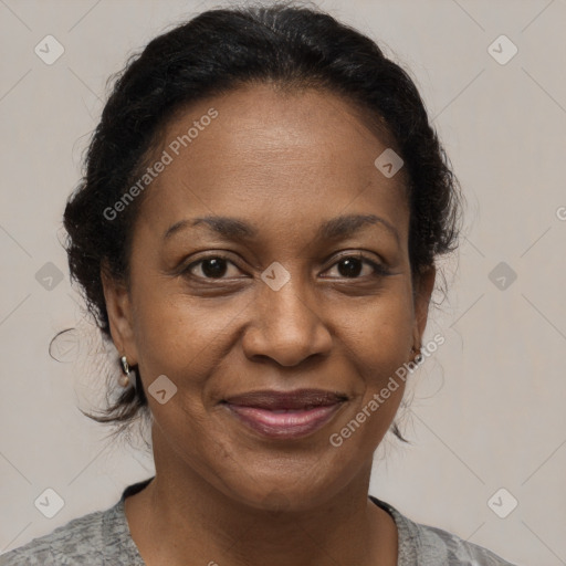 Joyful black adult female with medium  brown hair and brown eyes