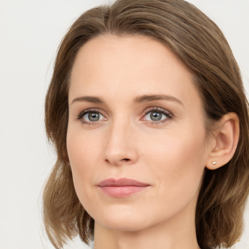 Joyful white young-adult female with long  brown hair and green eyes