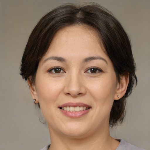 Joyful asian young-adult female with medium  brown hair and brown eyes