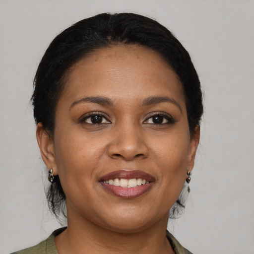 Joyful black young-adult female with medium  brown hair and brown eyes