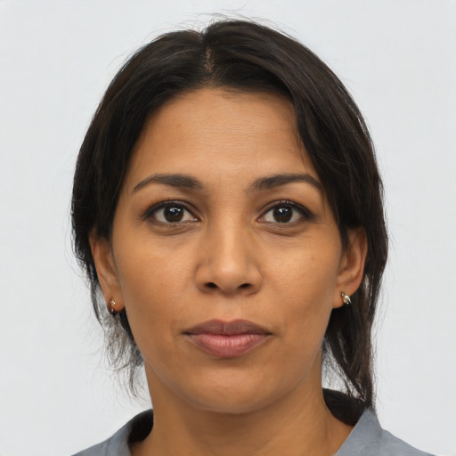 Joyful latino young-adult female with medium  brown hair and brown eyes