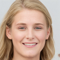 Joyful white young-adult female with long  brown hair and blue eyes