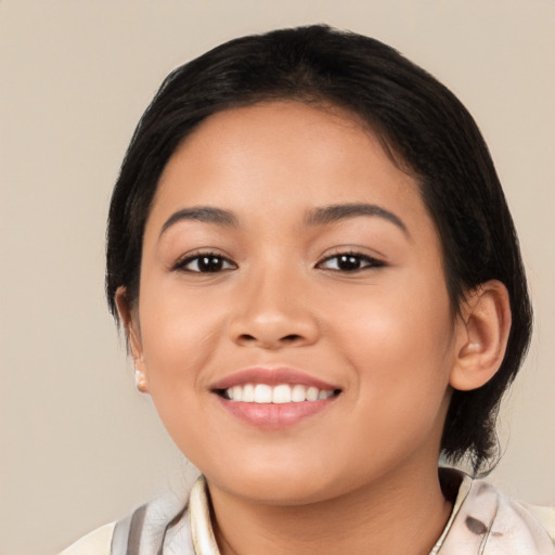 Joyful latino young-adult female with medium  black hair and brown eyes