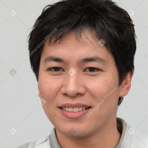 Joyful asian young-adult male with short  brown hair and brown eyes