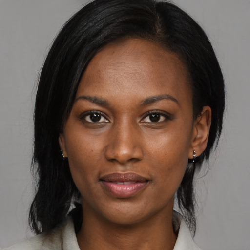 Joyful black young-adult female with medium  black hair and brown eyes