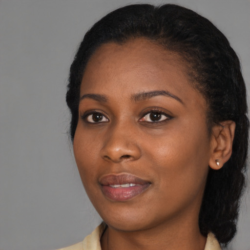 Joyful black young-adult female with medium  black hair and brown eyes