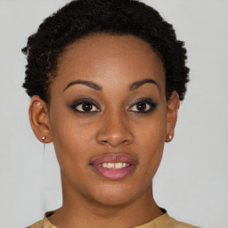 Joyful black young-adult female with short  brown hair and brown eyes