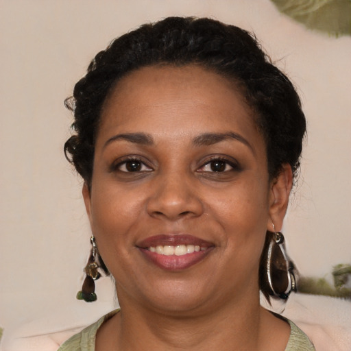Joyful black young-adult female with medium  black hair and brown eyes