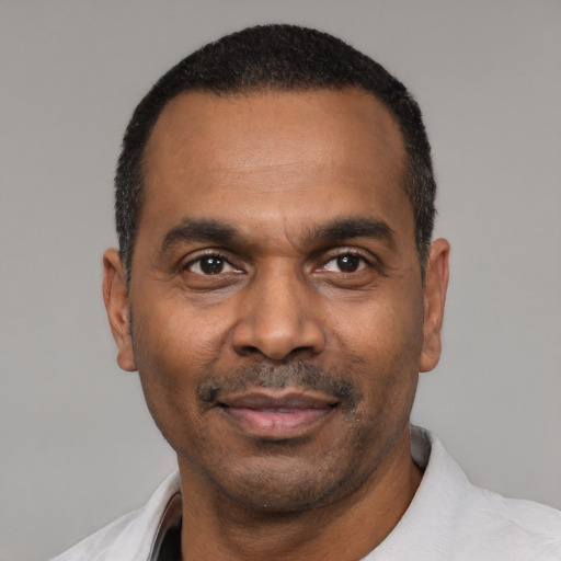 Joyful latino adult male with short  black hair and brown eyes