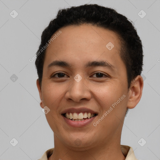 Joyful latino young-adult male with short  black hair and brown eyes