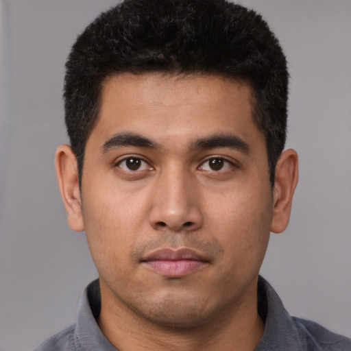 Neutral latino young-adult male with short  black hair and brown eyes