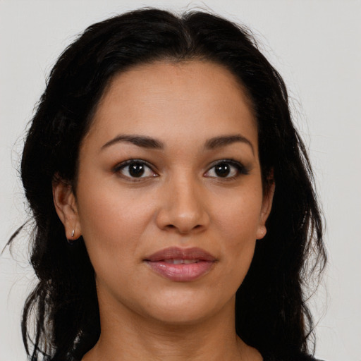 Joyful latino young-adult female with long  brown hair and brown eyes