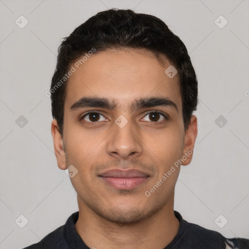 Joyful latino young-adult male with short  black hair and brown eyes