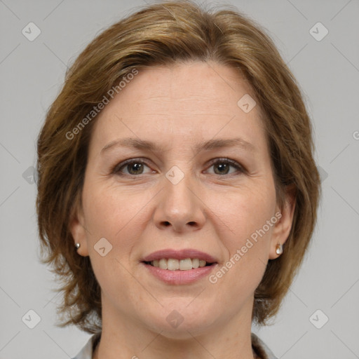 Joyful white adult female with medium  brown hair and brown eyes