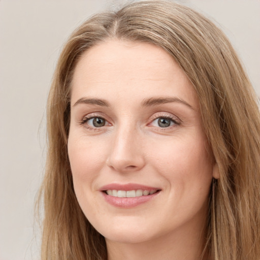 Joyful white young-adult female with long  brown hair and grey eyes