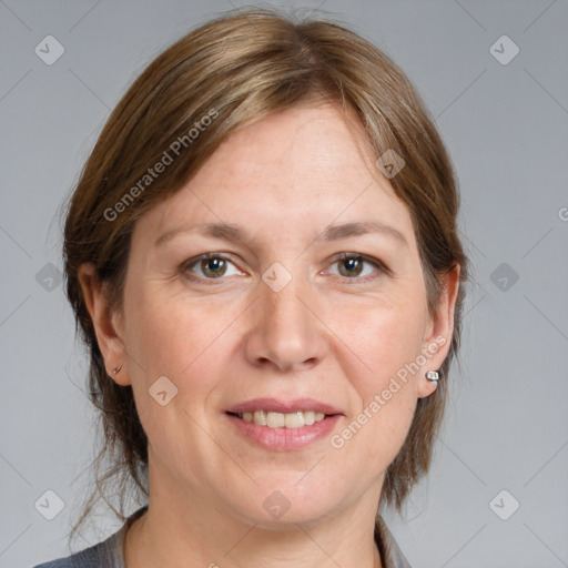 Joyful white adult female with medium  brown hair and grey eyes