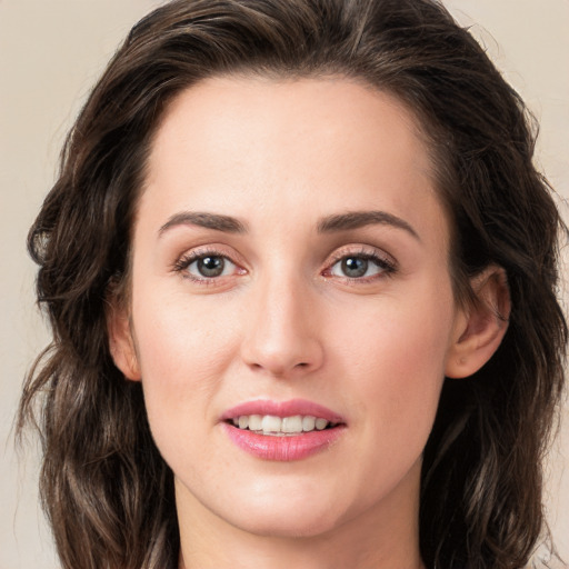 Joyful white young-adult female with long  brown hair and green eyes