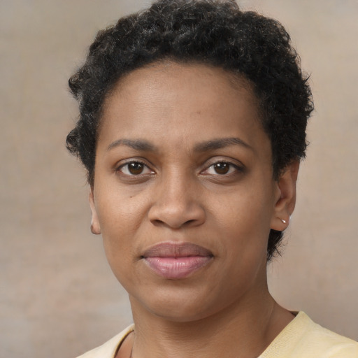 Joyful black young-adult female with short  brown hair and brown eyes
