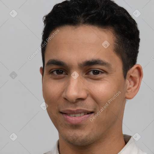 Joyful white young-adult male with short  black hair and brown eyes