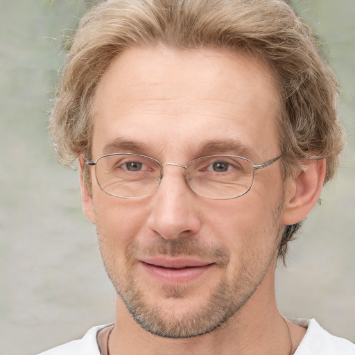 Joyful white adult male with short  brown hair and grey eyes