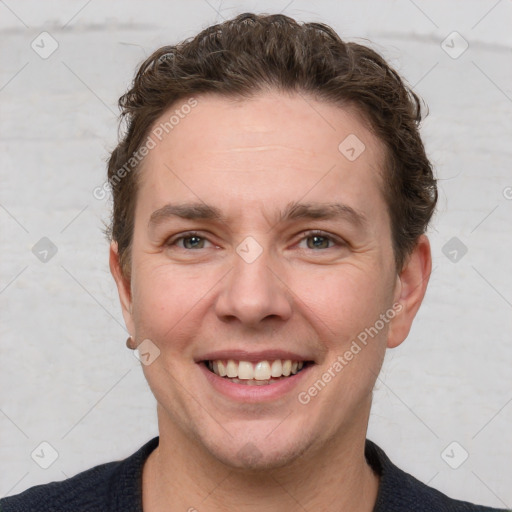 Joyful white adult male with short  brown hair and grey eyes