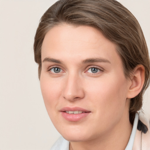 Joyful white young-adult female with medium  brown hair and grey eyes