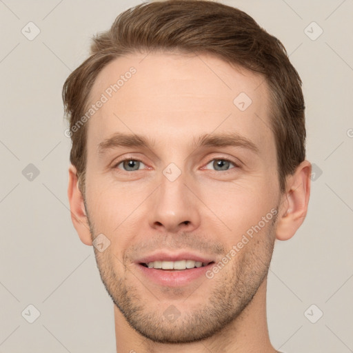 Joyful white young-adult male with short  brown hair and grey eyes