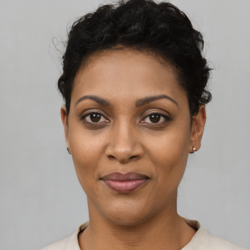 Joyful latino young-adult female with short  black hair and brown eyes