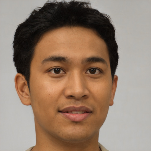Joyful latino young-adult male with short  brown hair and brown eyes