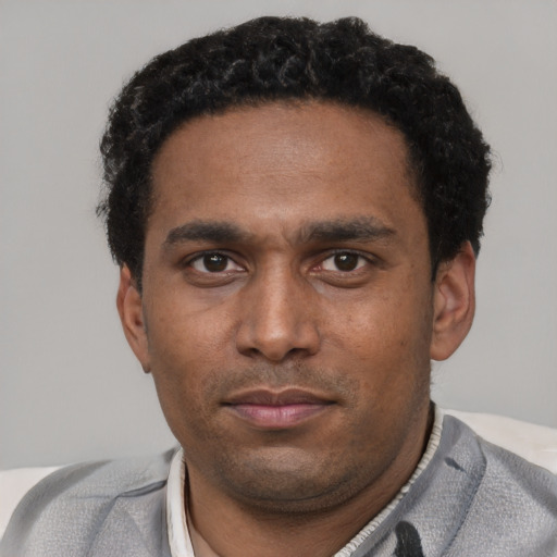 Neutral black young-adult male with short  black hair and brown eyes