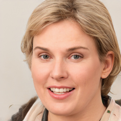 Joyful white young-adult female with medium  brown hair and blue eyes