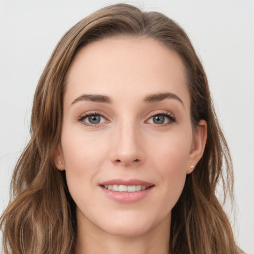 Joyful white young-adult female with long  brown hair and grey eyes