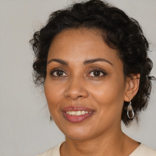 Joyful black adult female with medium  brown hair and brown eyes