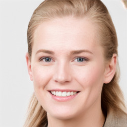 Joyful white young-adult female with long  brown hair and blue eyes