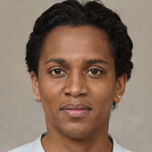 Joyful black young-adult male with short  brown hair and brown eyes