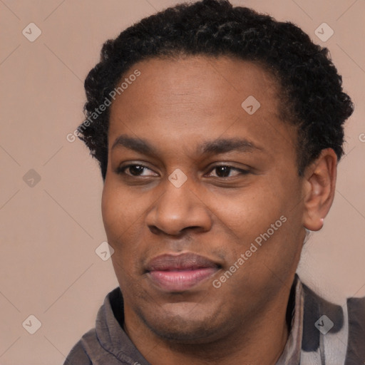 Joyful black young-adult male with short  black hair and brown eyes