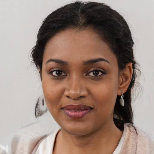 Joyful black young-adult female with medium  brown hair and brown eyes