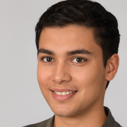 Joyful white young-adult male with short  black hair and brown eyes