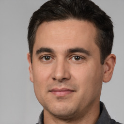 Joyful white young-adult male with short  brown hair and brown eyes