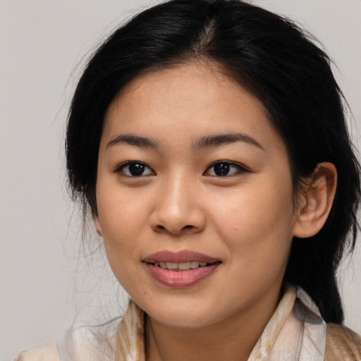 Joyful asian young-adult female with medium  brown hair and brown eyes